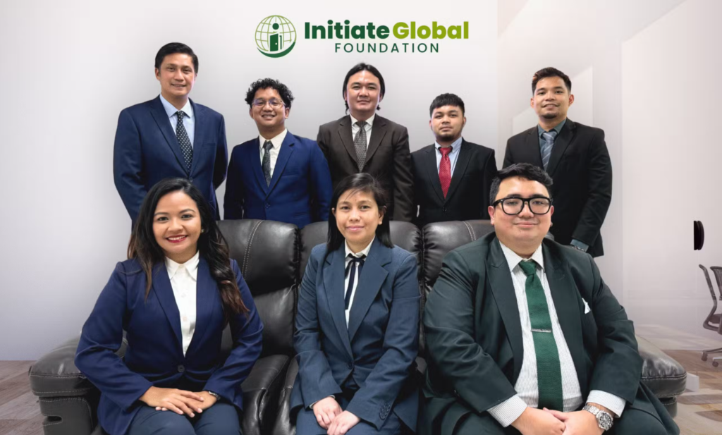 Group of professionals in suits with Initiate Global Foundation Logo